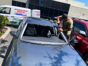 A skilled technician repairing a windshield in San Diego.